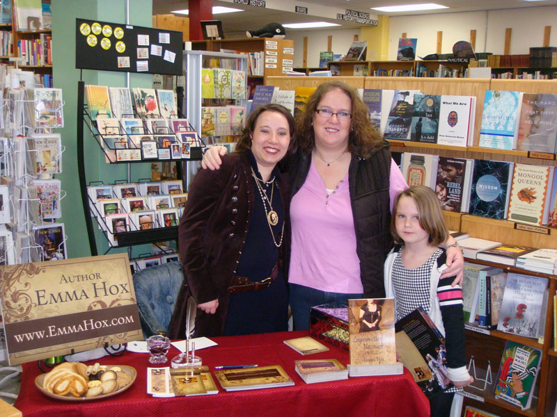 Emmaline signing books for her friend Ramona at the book signing at Orca Books Cooperative in Olympia Washington.